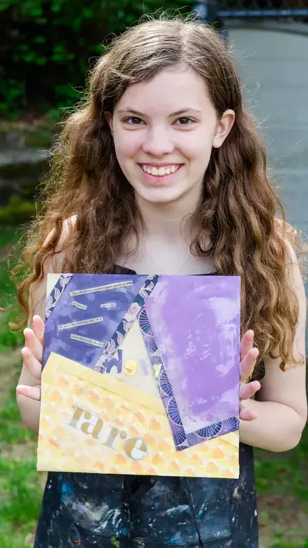 Student holding artwork