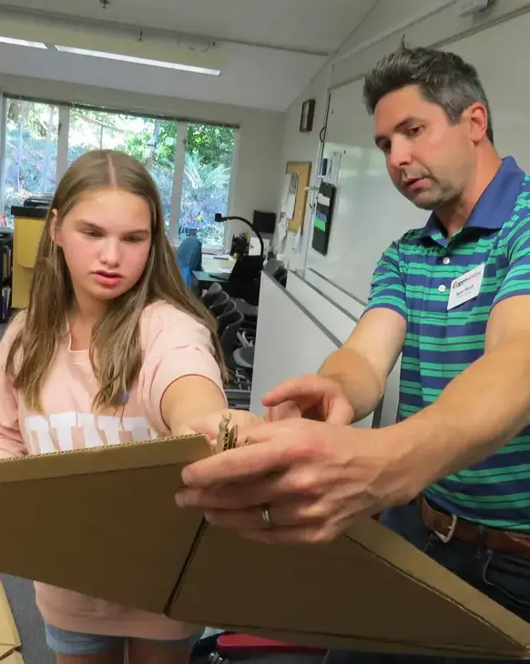 Teacher helping student with project