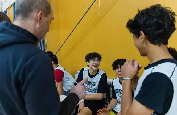 Coach talking to students