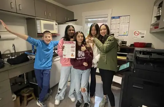 Students holding newspaper