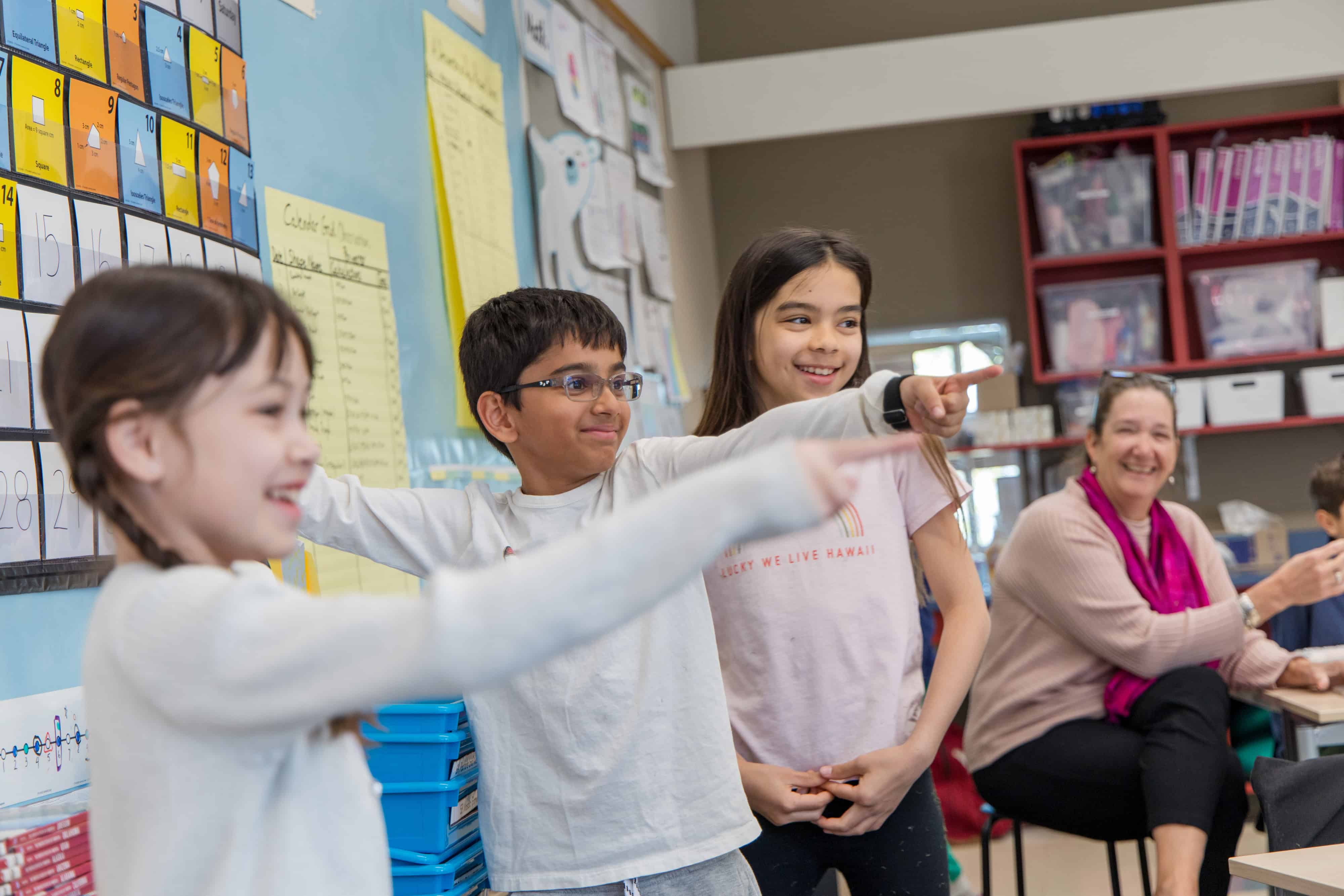 Students pointing in class
