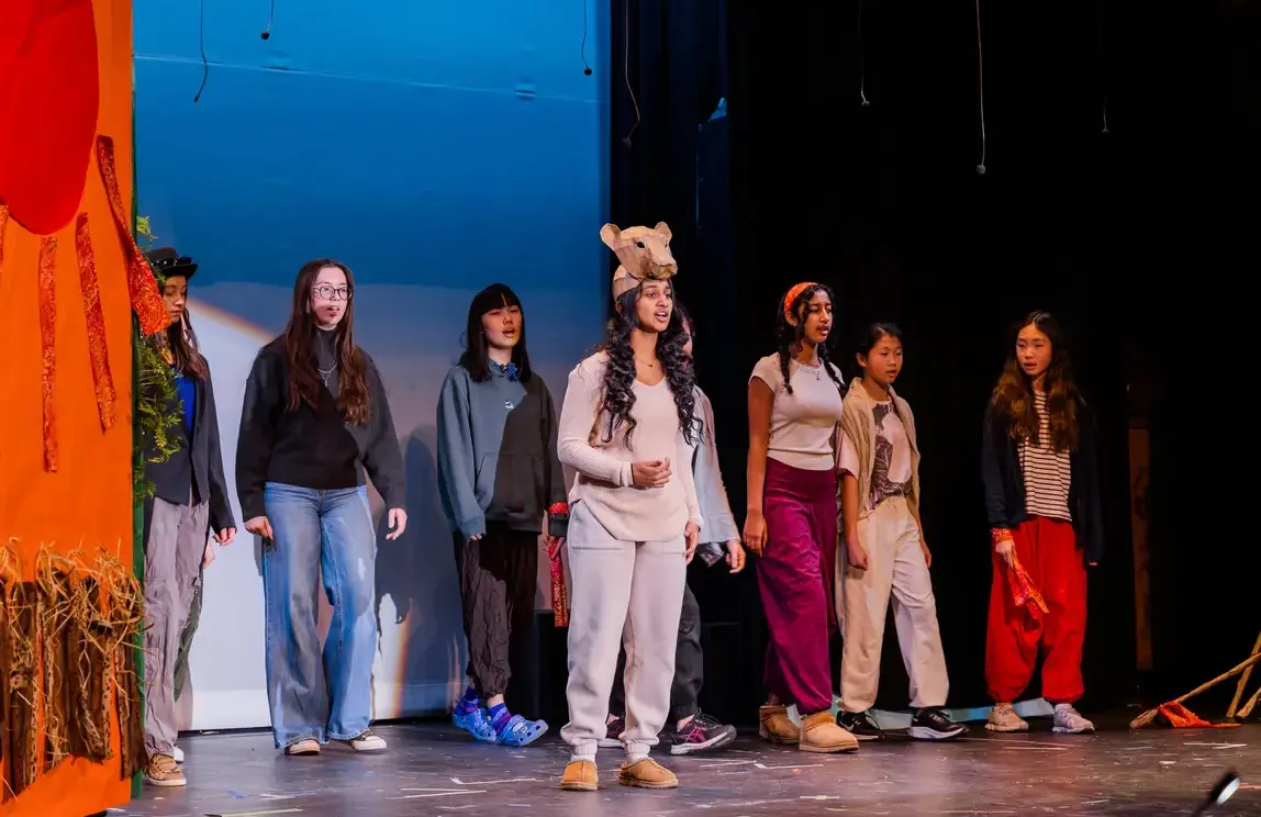 Students performing in theatre