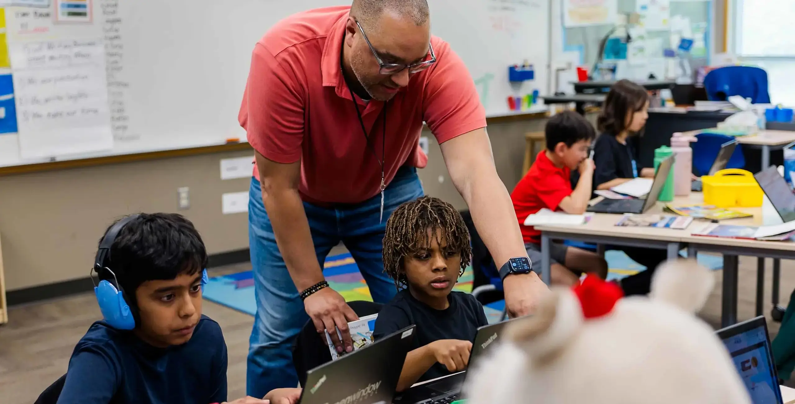 Teacher helping students in class