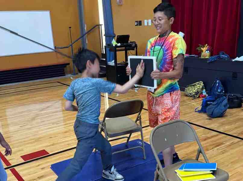 Student chopping at board