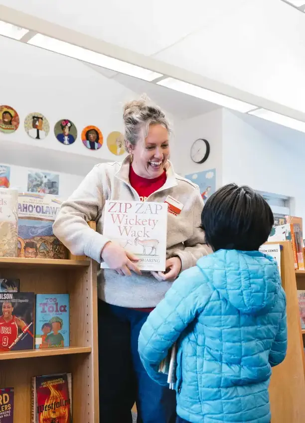 Teacher showing student a book 