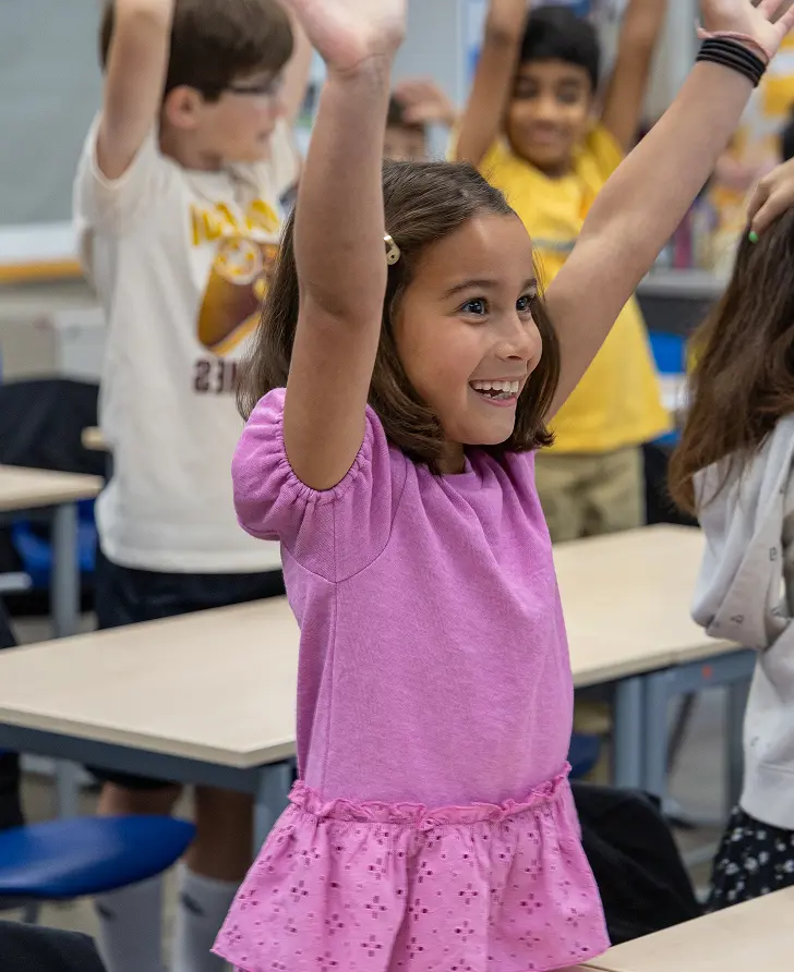 Female student in class smiling